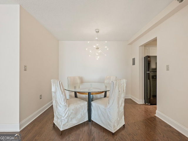 dining space with a notable chandelier and dark hardwood / wood-style floors