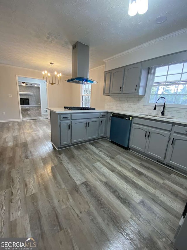 kitchen with sink, dishwasher, black gas cooktop, island range hood, and kitchen peninsula