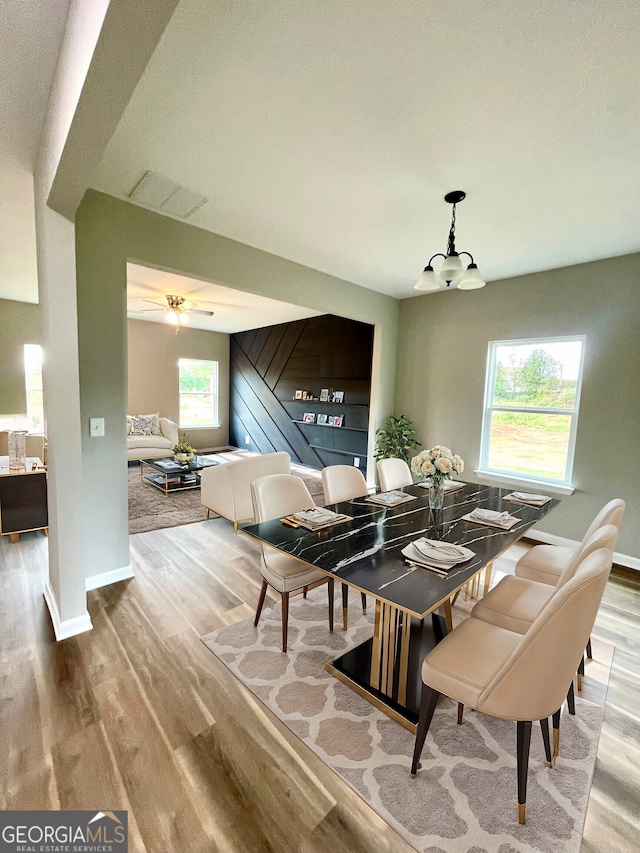 dining area featuring wood-type flooring and plenty of natural light