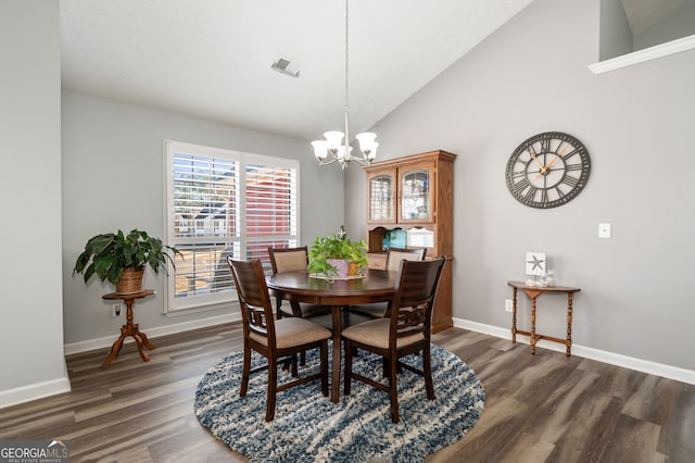 dining area with an inviting chandelier, high vaulted ceiling, and dark hardwood / wood-style floors