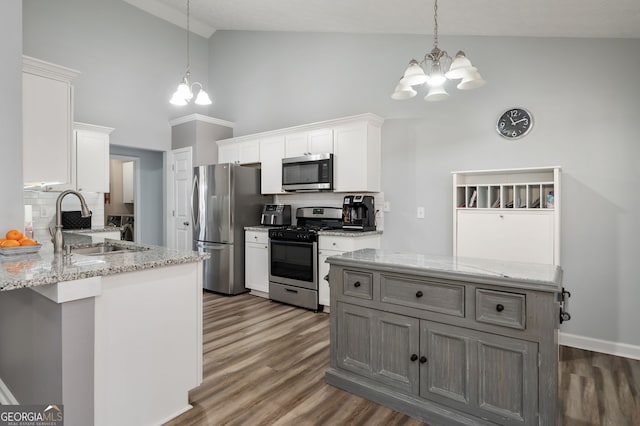 kitchen featuring a notable chandelier, white cabinets, and appliances with stainless steel finishes