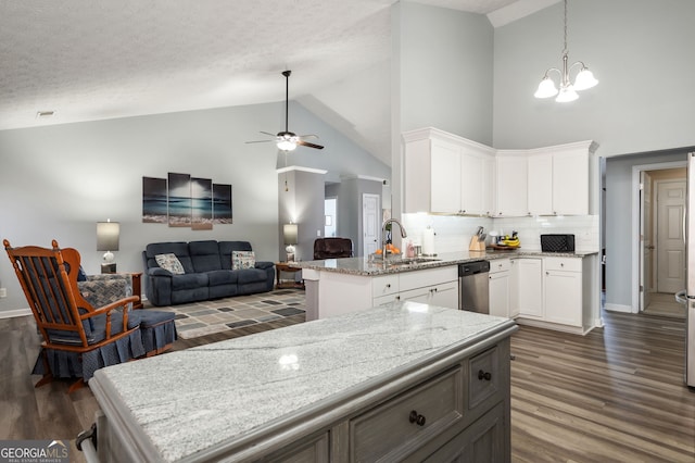 kitchen featuring pendant lighting, dark wood-type flooring, light stone countertops, and white cabinets