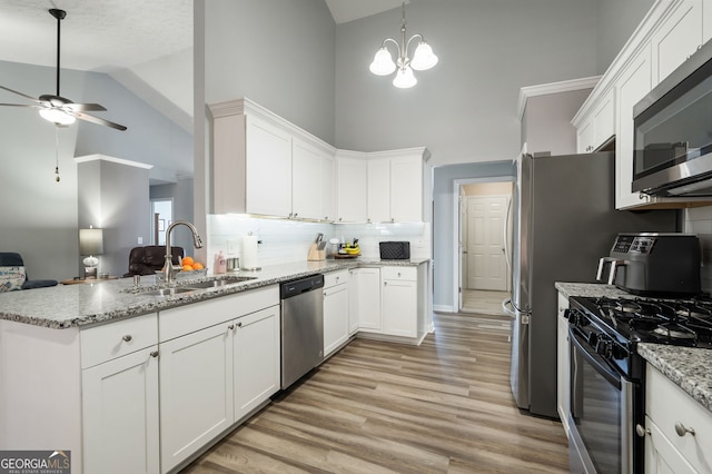 kitchen with appliances with stainless steel finishes, sink, and white cabinets