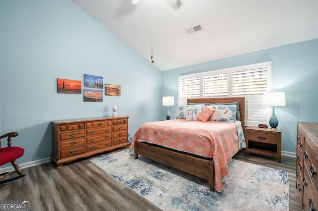 bedroom featuring ceiling fan, lofted ceiling, and dark hardwood / wood-style floors