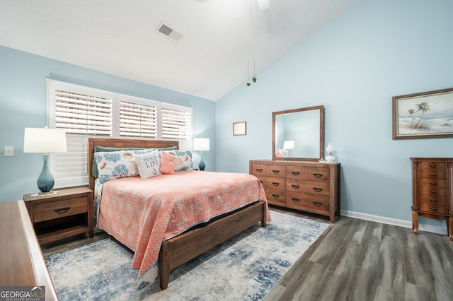 bedroom with ceiling fan, high vaulted ceiling, and dark hardwood / wood-style flooring