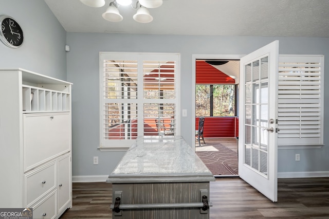 interior space with a chandelier, dark hardwood / wood-style floors, a textured ceiling, and french doors