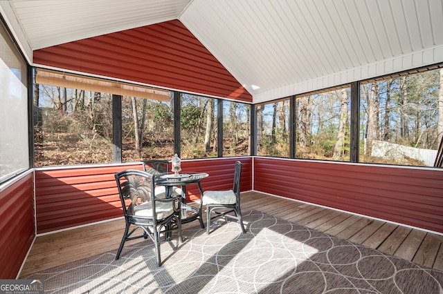 unfurnished sunroom featuring vaulted ceiling