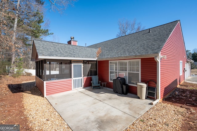 back of property featuring a patio area and a sunroom