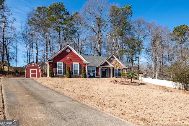 single story home featuring a storage shed