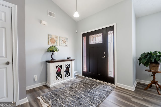 entryway with lofted ceiling and dark wood-type flooring