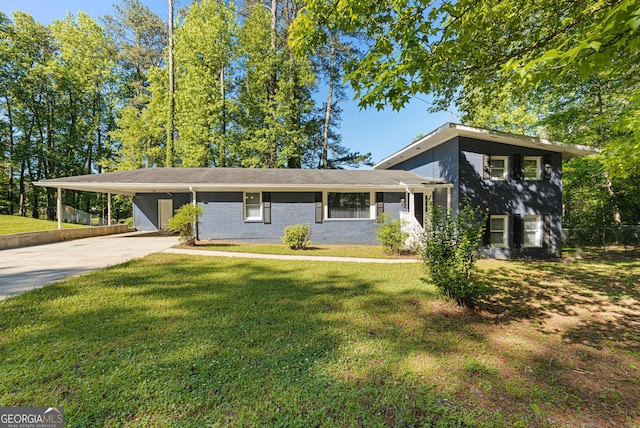 split level home featuring a front lawn and a carport