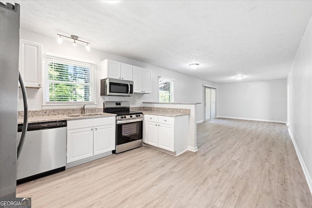 kitchen with white cabinetry, sink, a textured ceiling, and appliances with stainless steel finishes