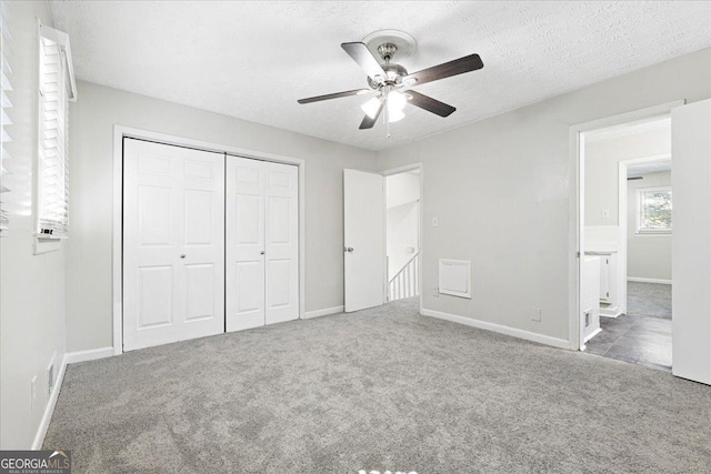 unfurnished bedroom featuring ceiling fan, carpet, a textured ceiling, and a closet