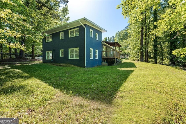 view of side of home with a lawn and a deck