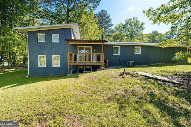 back of property with a wooden deck, a yard, and cooling unit