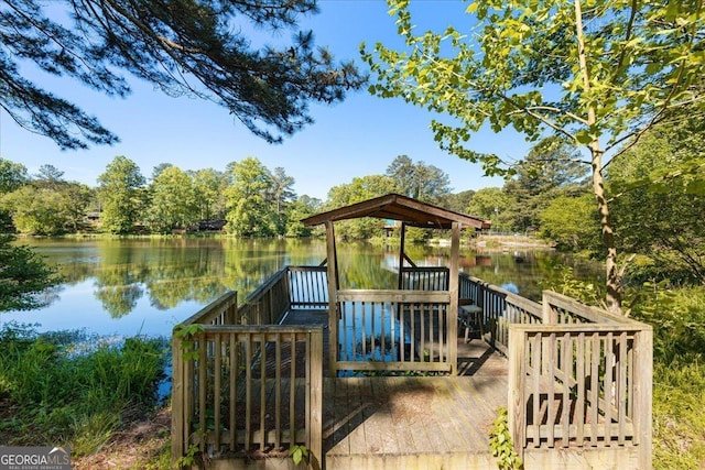 wooden terrace featuring a water view