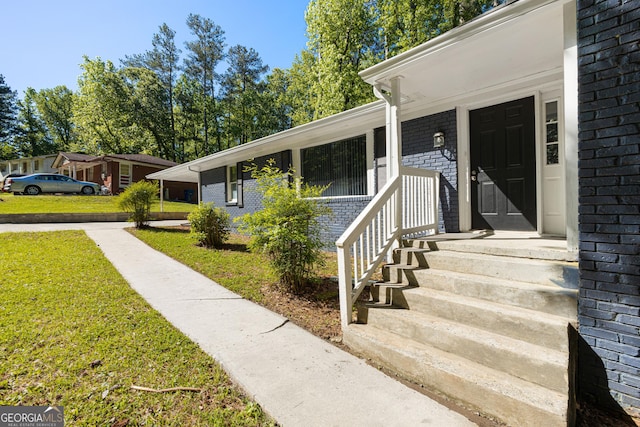 entrance to property with a yard