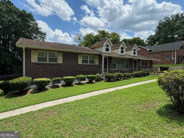 view of front of home with a front yard and covered porch