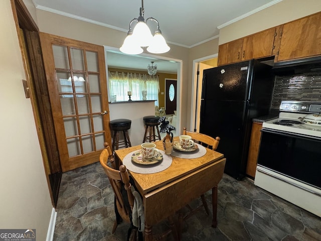 dining area featuring crown molding and a chandelier