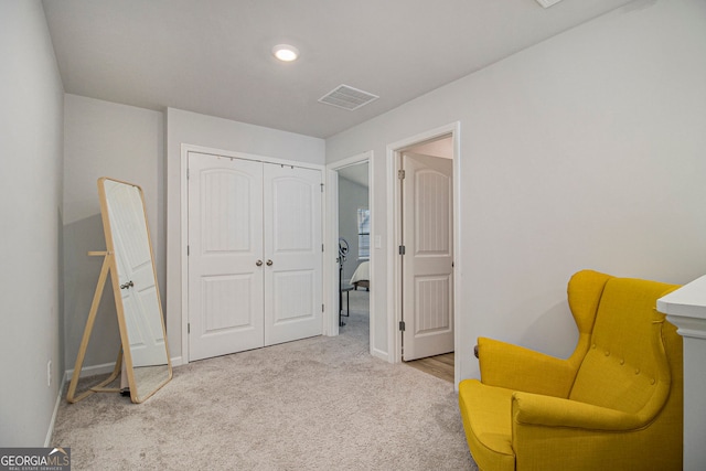 living area featuring light carpet