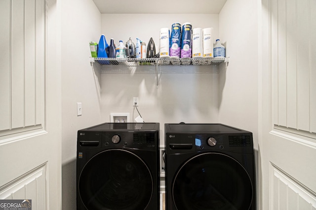 clothes washing area featuring washer and clothes dryer