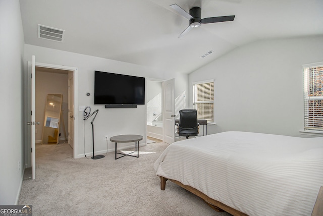 carpeted bedroom featuring ceiling fan, ensuite bathroom, and vaulted ceiling