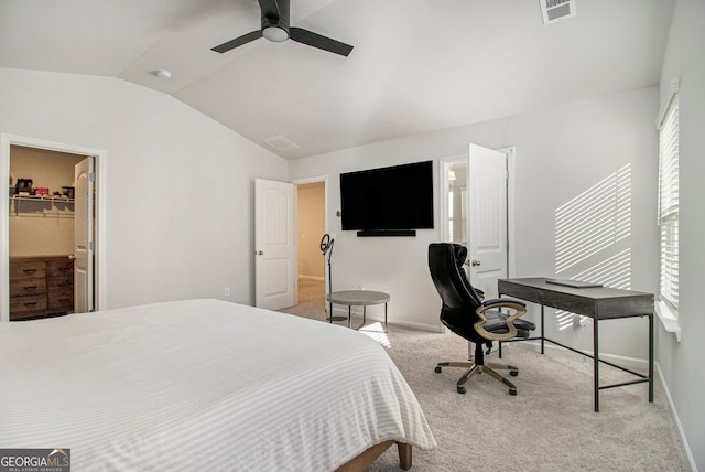 carpeted bedroom featuring lofted ceiling, a spacious closet, a closet, and ceiling fan