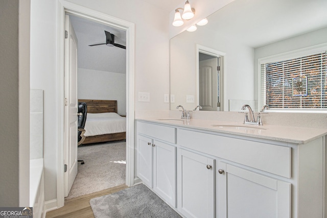 bathroom featuring vanity, hardwood / wood-style floors, and ceiling fan