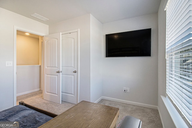 unfurnished bedroom with light carpet and a closet