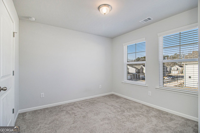 spare room with light carpet