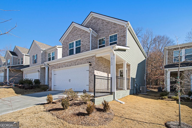 view of front of property with a garage and central AC unit