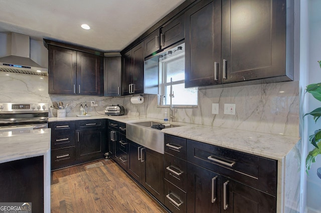 kitchen with wall chimney exhaust hood, dark hardwood / wood-style floors, and decorative backsplash