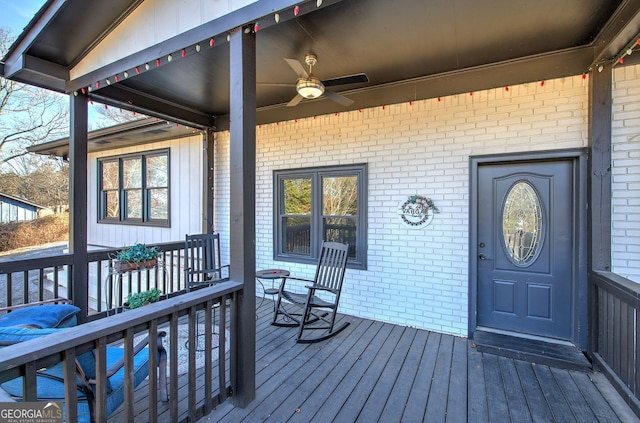 wooden terrace with a porch and ceiling fan