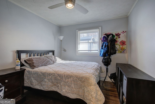 bedroom with ornamental molding, ceiling fan, a textured ceiling, and dark hardwood / wood-style flooring