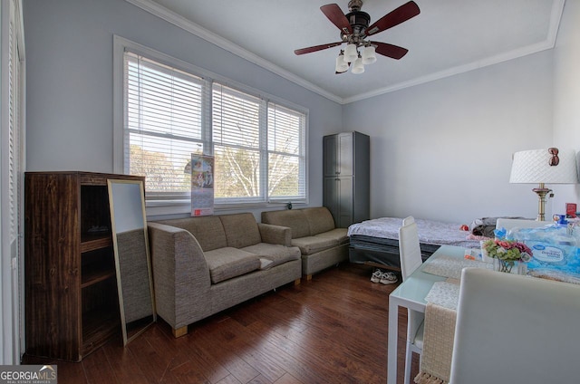 bedroom with crown molding, dark wood-type flooring, and ceiling fan