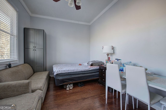 bedroom with dark wood-type flooring, ceiling fan, and crown molding