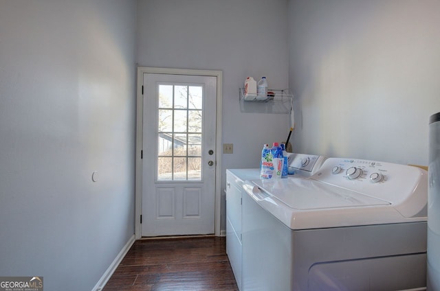 laundry area with separate washer and dryer and dark wood-type flooring