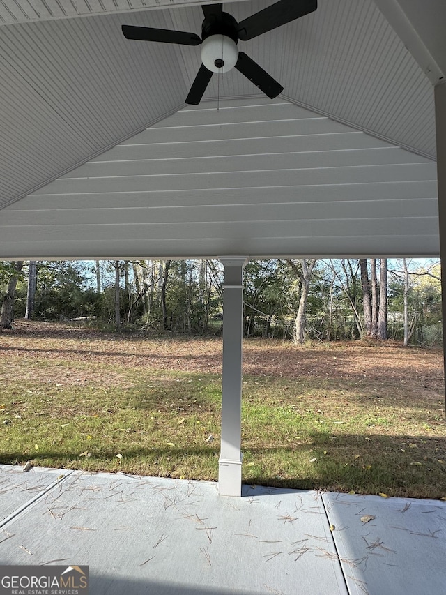 view of car parking featuring ceiling fan and a lawn