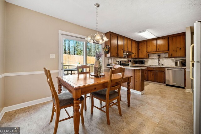 dining room with sink and an inviting chandelier