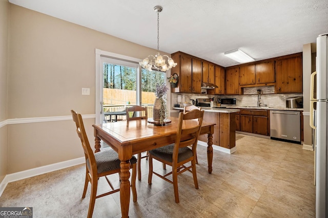 dining space with an inviting chandelier and sink