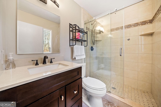 bathroom featuring vanity, walk in shower, and toilet