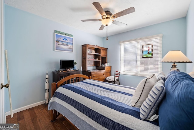 bedroom featuring a textured ceiling, dark wood-type flooring, and ceiling fan