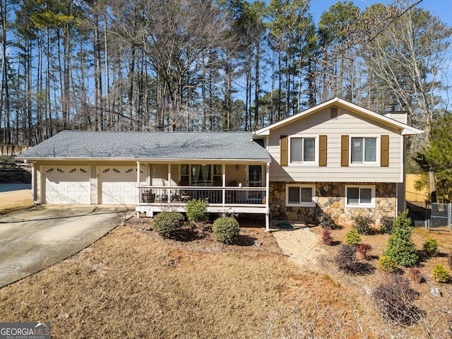 tri-level home featuring a garage and a porch