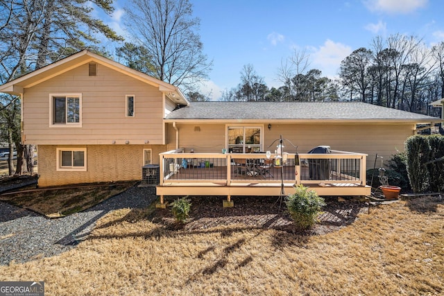 rear view of house with a wooden deck and cooling unit