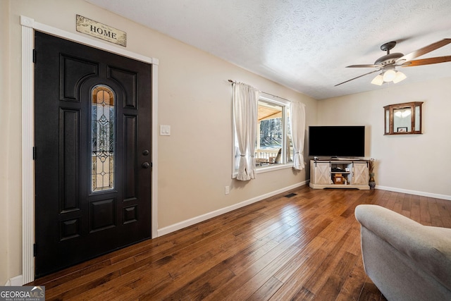 entryway with ceiling fan, hardwood / wood-style flooring, and a textured ceiling