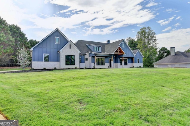 modern inspired farmhouse with a front lawn