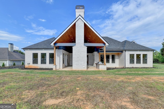 back of property featuring a yard and a patio area