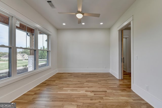 empty room featuring ceiling fan and light wood-type flooring