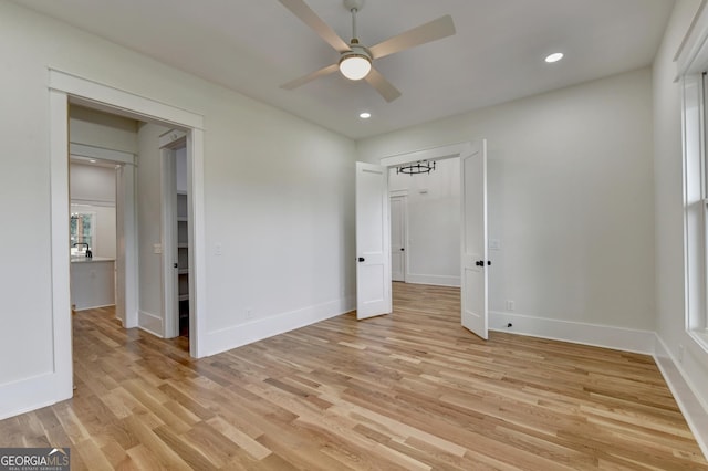 unfurnished bedroom with ceiling fan and light wood-type flooring