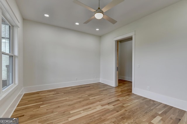 spare room featuring ceiling fan and light hardwood / wood-style floors